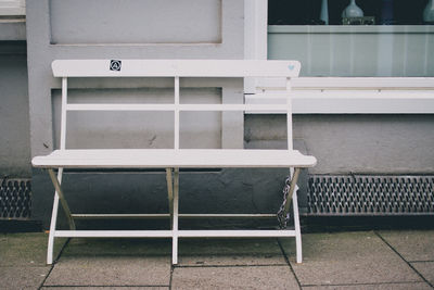 Empty bench against the wall