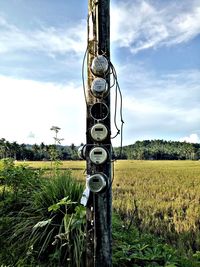 Metallic structure on field against sky