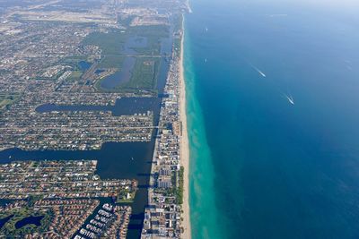 Aerial view of city by sea