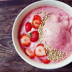 Directly above shot of strawberry ice cream in bowl on table