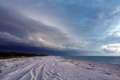 Dramatic stormy clouds forming over white sand beach in celestún, yucatán, méxico.