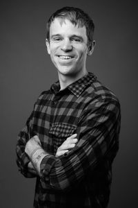 Portrait of a smiling young man against gray background