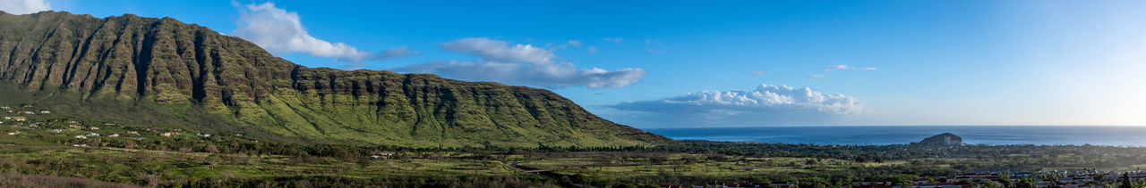 Panoramic view of sea and mountains against sky