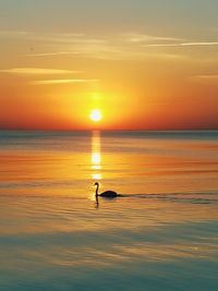 Scenic view of sea against orange sky