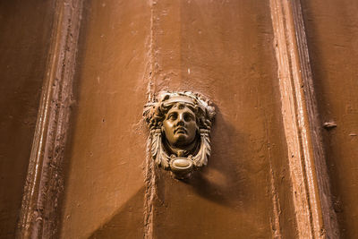 Low angle view of statue against wall