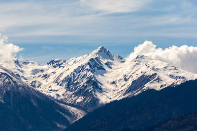 Scenic view of snowcapped mountains against sky