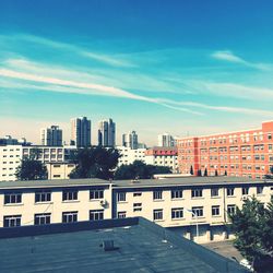 Buildings against cloudy sky