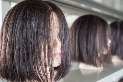 Close-up of wigs on mannequins at store