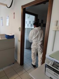 Rear view of man standing at entrance