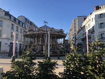 Street amidst buildings against clear sky