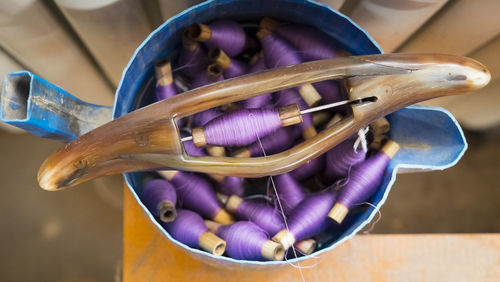 Spools of colorful thread in bucket