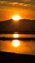 Scenic view of lake against romantic sky at sunset