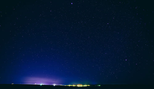 Low angle view of illuminated buildings against sky at night