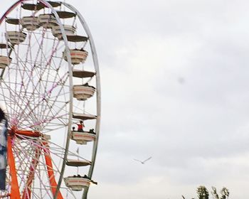 Low angle view of ferris wheel against sky