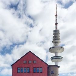 Low angle view of building against cloudy sky