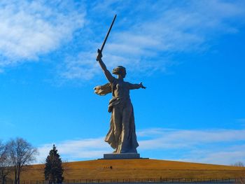 Low angle view of statue against blue sky