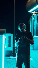 Man photographing illuminated smart phone