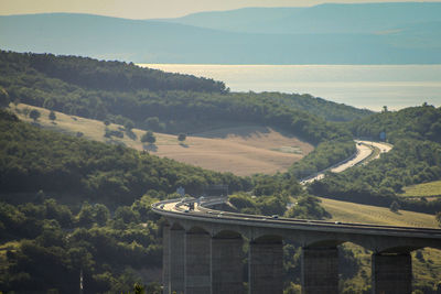High angle view of bridge on mountain against sky