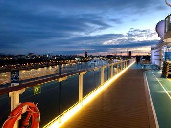 Illuminated buildings against sky at sunset