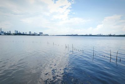 Scenic view of sea against sky in city