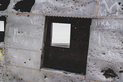 Close-up of broken glass window of old building