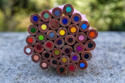 Close-up of colored pencils on retaining wall