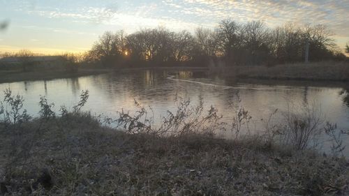 Scenic view of lake at sunset