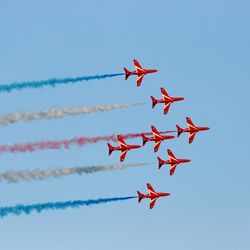 Low angle view of airshow against clear sky