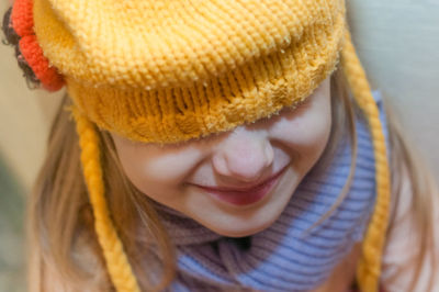 Close-up portrait of a girl with hat