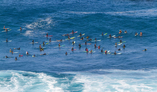 High angle view of people surfing in sea