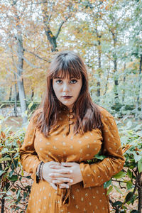 Portrait of young woman sitting on field