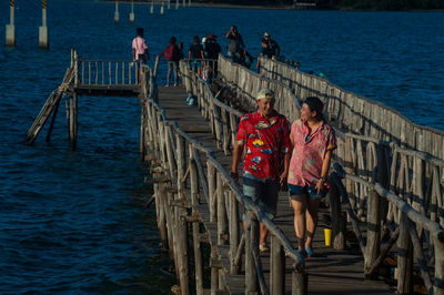 High angle view of couple on pier over sea