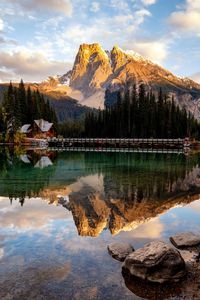 Scenic view of lake by mountains against sky