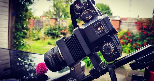 Close-up of camera on metal in city