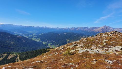 Scenic view of mountains against blue sky