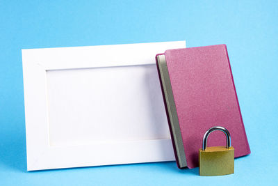 High angle view of books on table against blue background