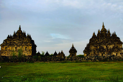 Historic building on field against sky