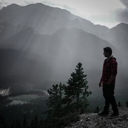 Rear view of man standing on mountain