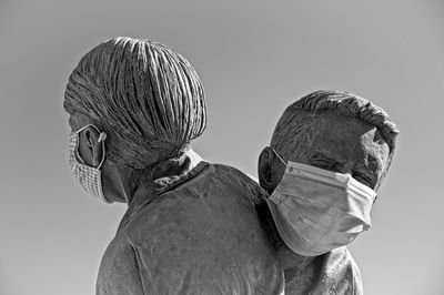 Rear view of man and woman against clear sky
