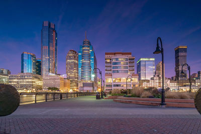 Illuminated buildings in city at dusk