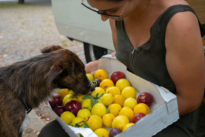 Full length of woman holding fruits