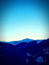 Scenic view of mountains against clear blue sky