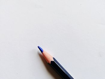 High angle view of colored pencils on white background