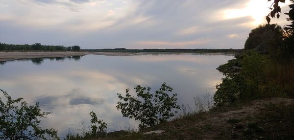 Scenic view of lake against sky during sunset