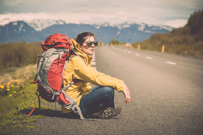 Woman sitting on road