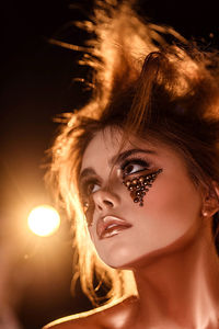 Close-up portrait of a girl in creative bronze make-up
