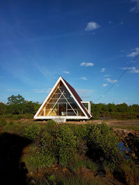 Built structure on land against blue sky