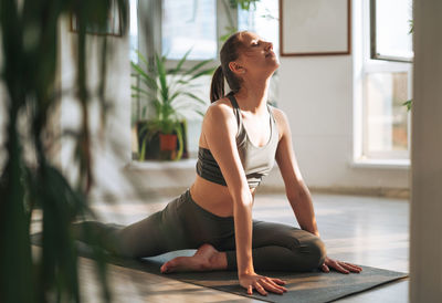 Young woman exercising in gym