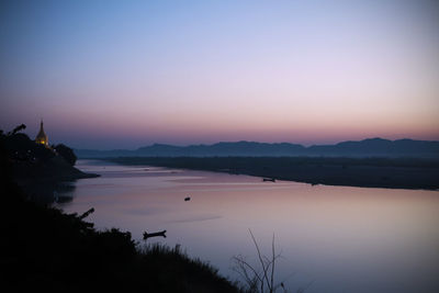 Scenic view of lake against sky at sunset