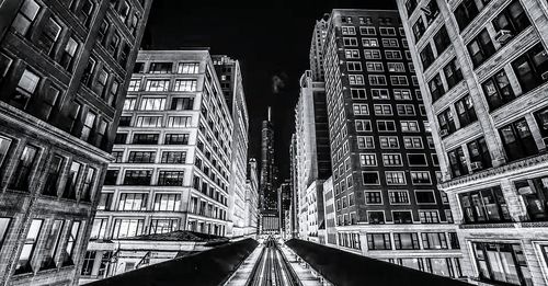 Road passing through city at night